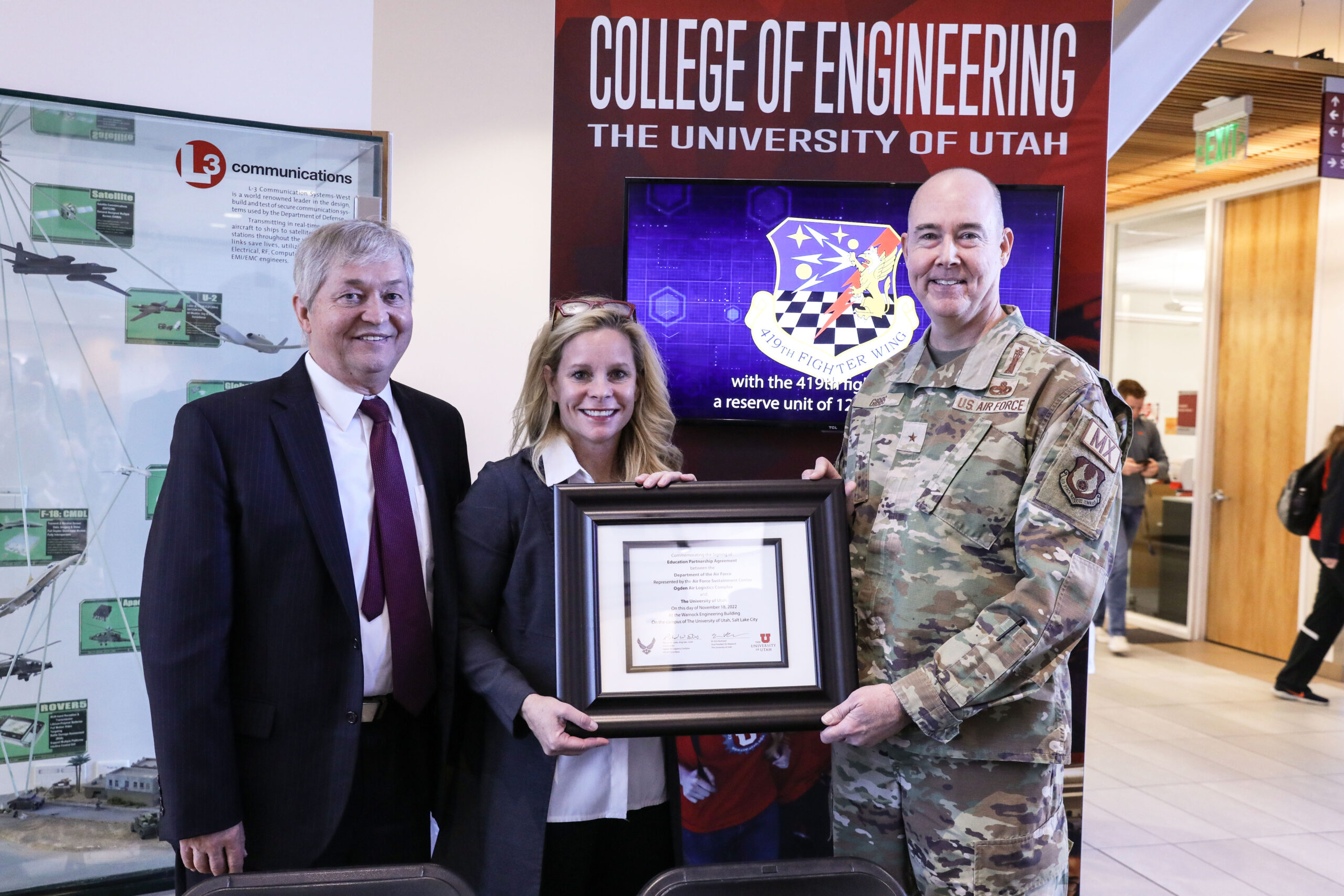 Dean Brown on the left, white woman in the middle, tall white bald man on the right