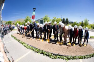 A row of dignitaries ceremonial break ground on the John and Marcia Price Computing and Engineering building