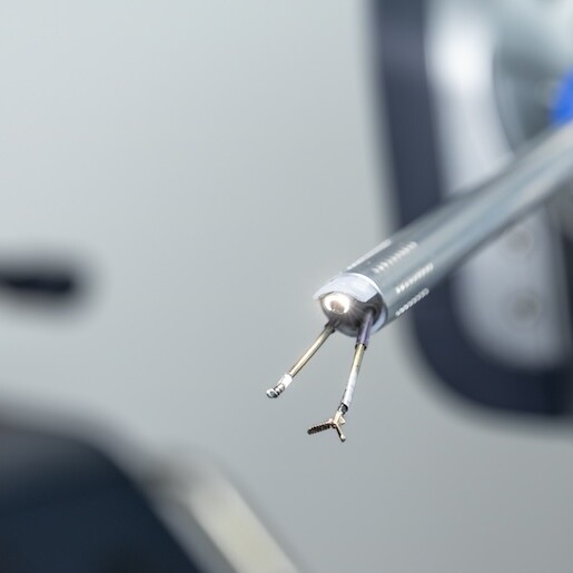 An extreme closeup of a medical robot, equipped with piercing and grasping tools