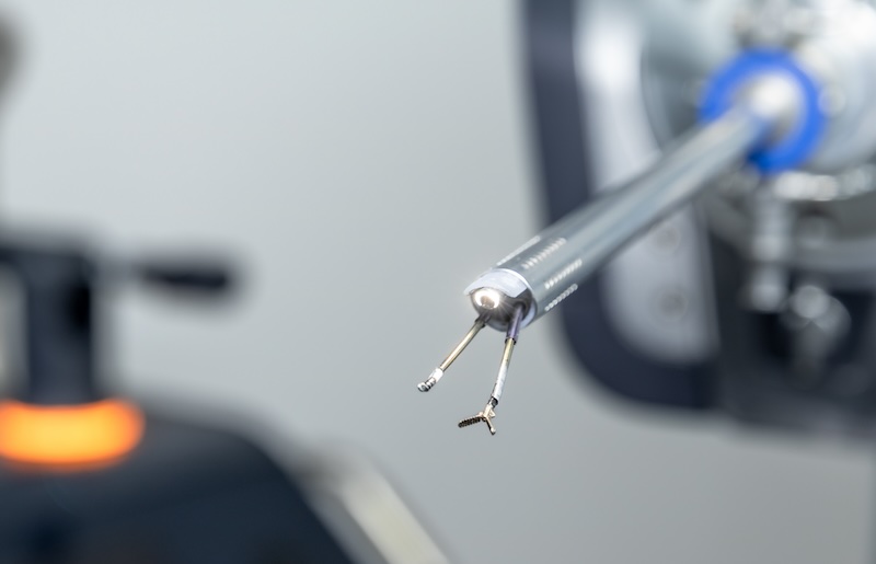 An extreme closeup of a medical robot, equipped with piercing and grasping tools