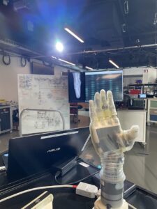 A robotic prosthetic hand under a spotlight