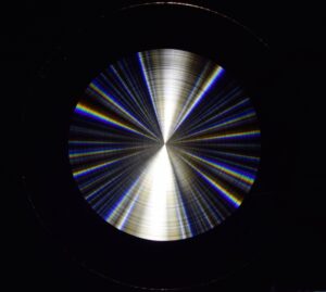 Rainbow light refracts off the concentric rings of the researchers' flat lens